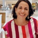 Smiling woman in a striped shirt.