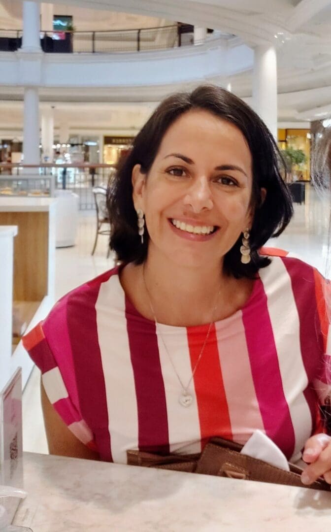 Smiling woman in a striped shirt.