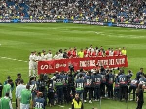 A group of soccer players standing on a field.