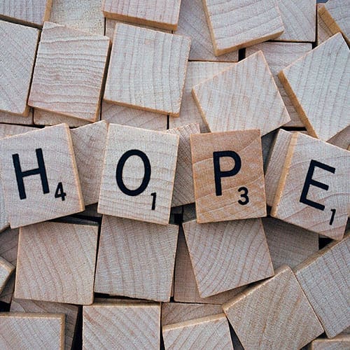 A pile of wooden blocks with the word hope.