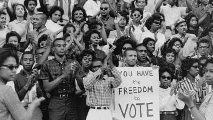 Crowd of people protesting for voting rights.