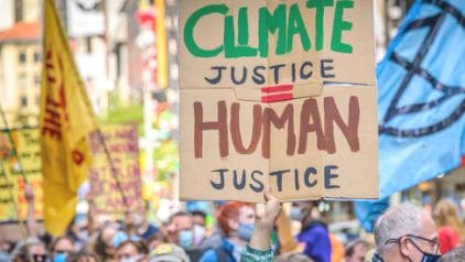 Protest sign: Climate justice equals human justice.