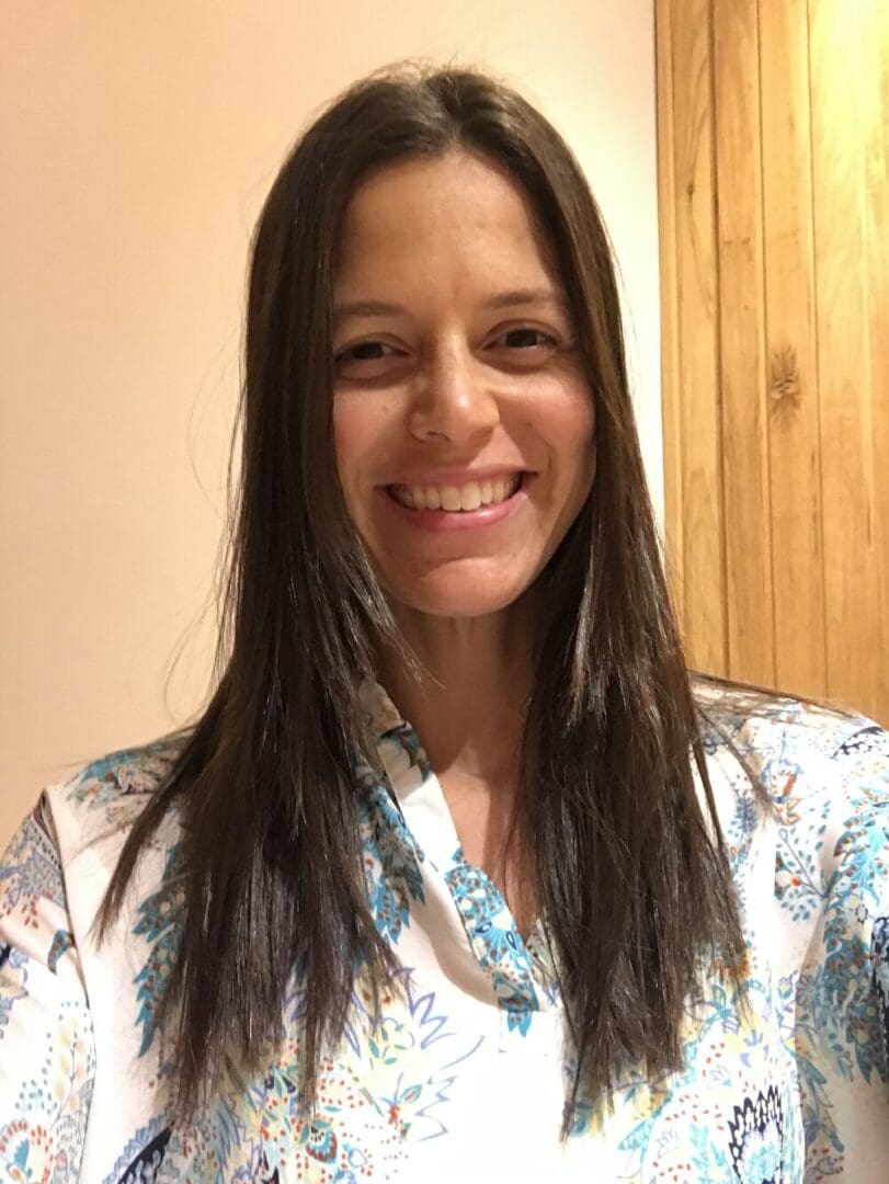 Smiling woman with long brown hair.