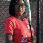 Young woman holding a baseball bat.