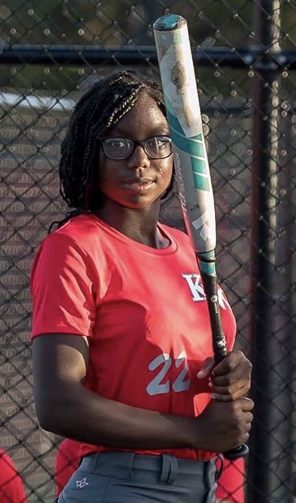 Young woman holding a baseball bat.