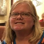 Woman smiling in a restaurant.