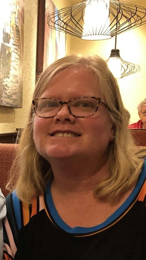 Woman smiling in a restaurant.