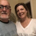 Couple wearing shirts with "As I have loved you"