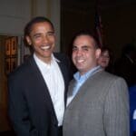 Barack Obama and man smiling at event.