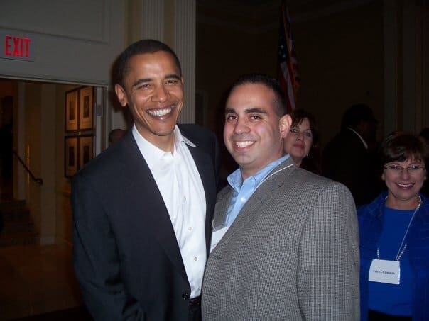 Barack Obama and man smiling at event.