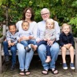 Family portrait on a wooden bench.