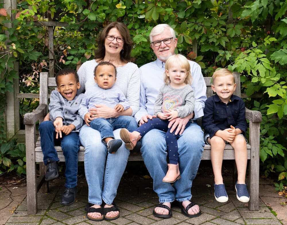 Family portrait on a wooden bench.