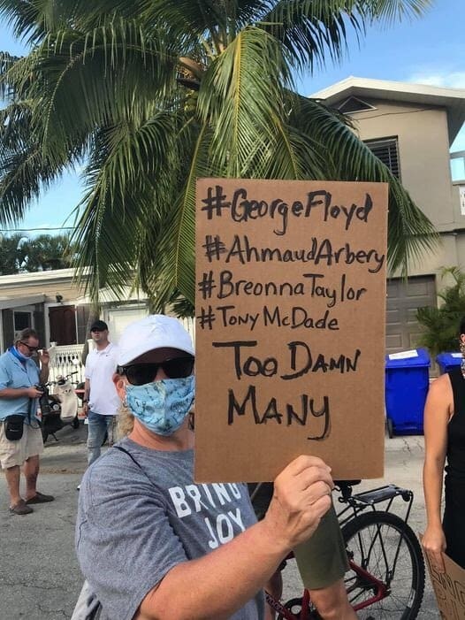 Protest sign listing names of victims