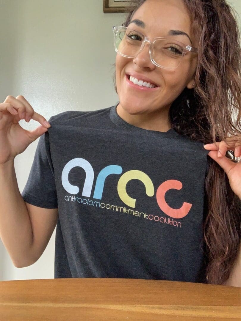 Woman wearing an Anti-Racism Commitment Coalition shirt.