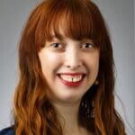 Woman with long red hair smiling