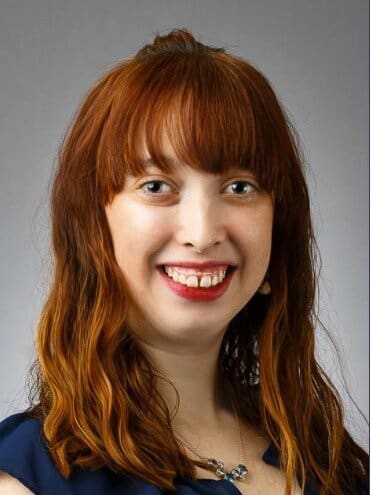 Woman with long red hair smiling