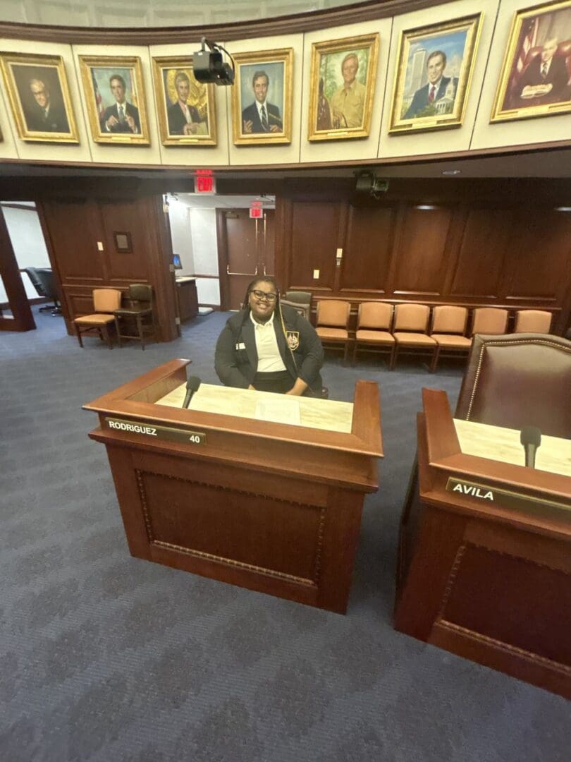 Young woman sitting at a government table.