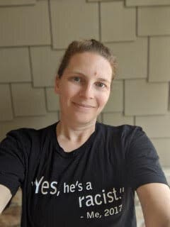 A woman wearing a t-shirt with a slogan.