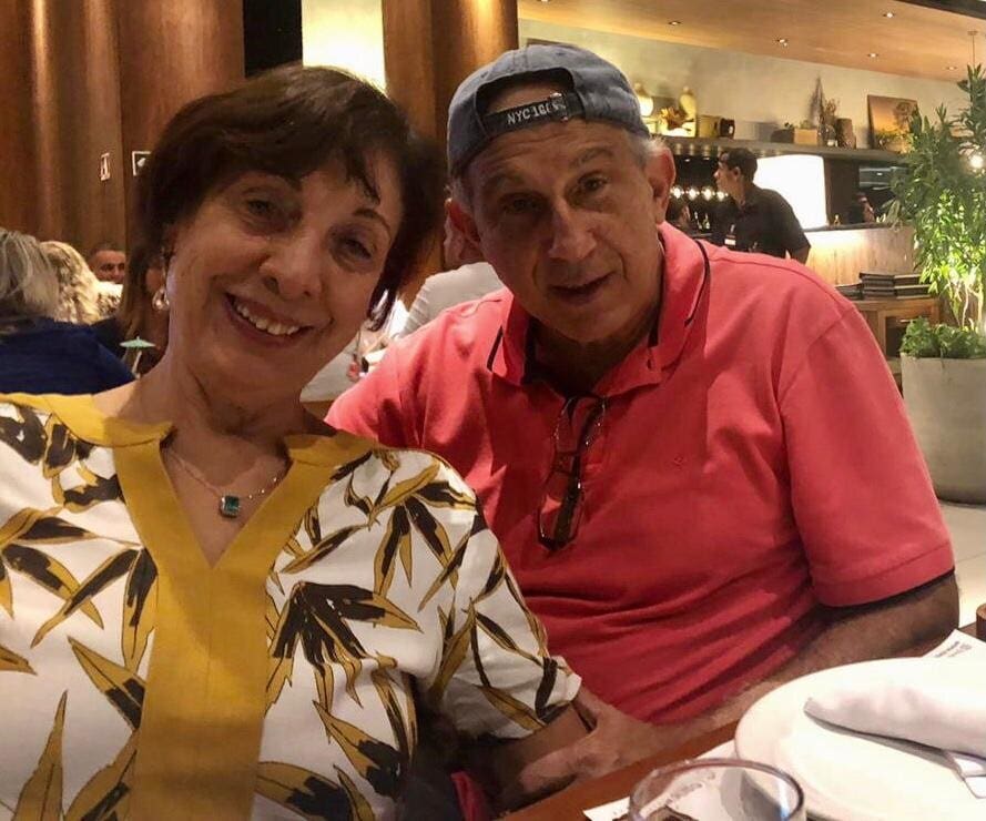 Smiling couple sitting at a restaurant table.