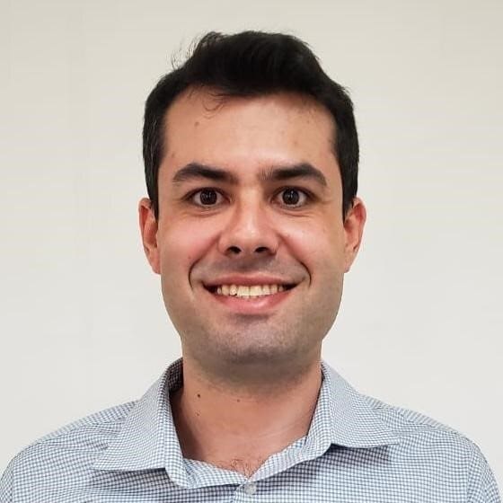 Smiling man in a light blue shirt.