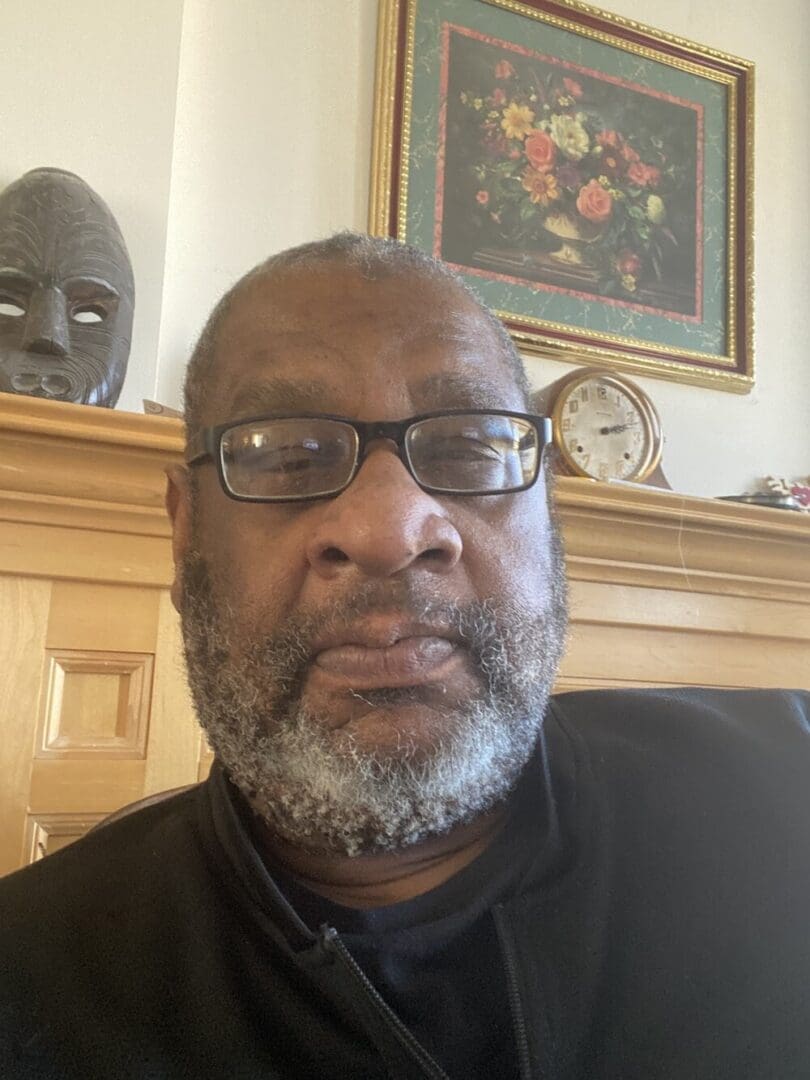 Headshot of a man wearing glasses.