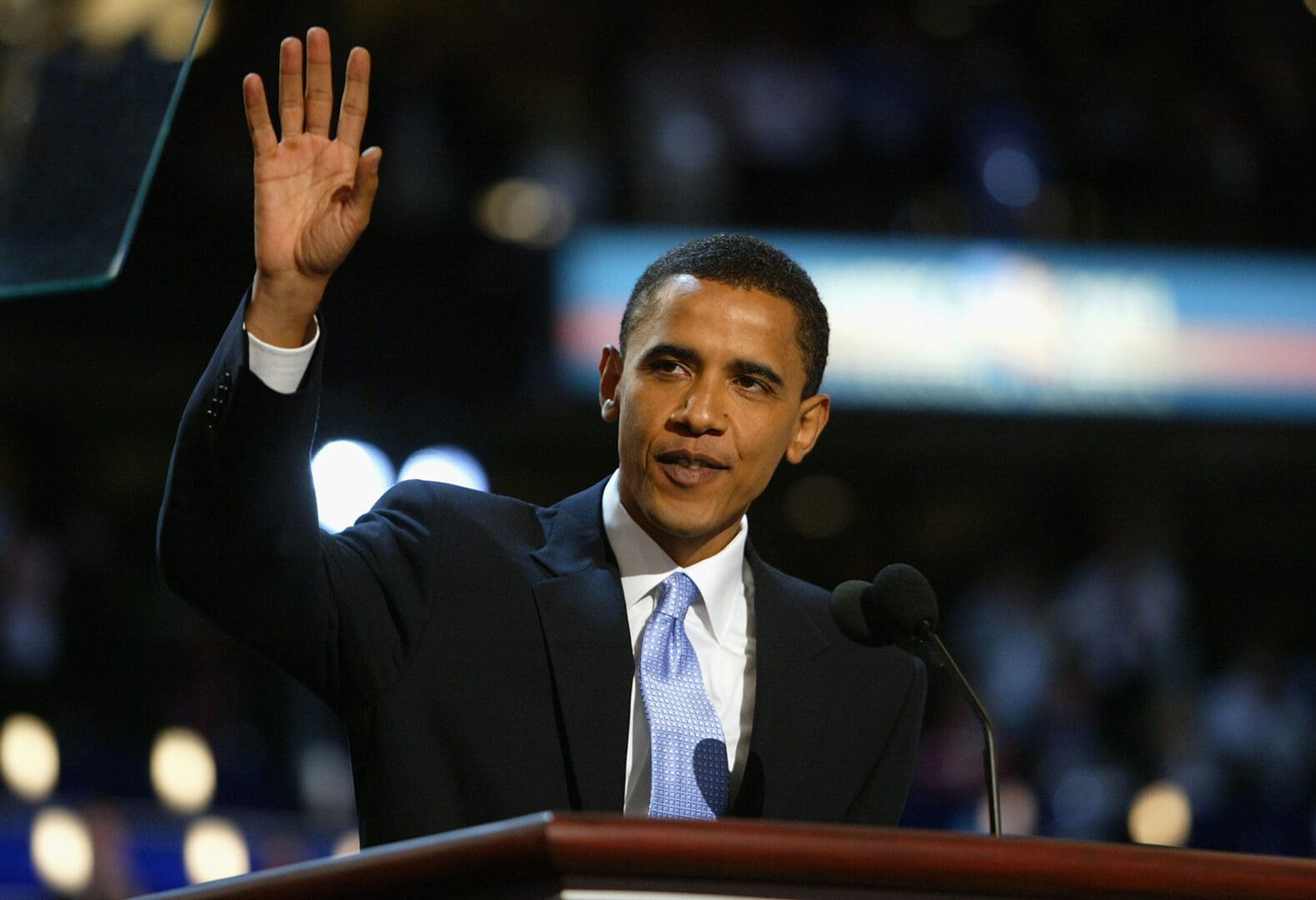 President Obama waves to the crowd, concluding his speech with a warm gesture of appreciation and connection.