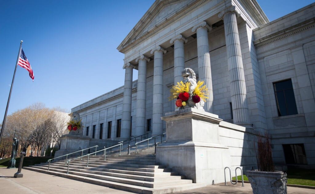 Neoclassical building entrance with American flag