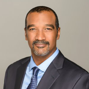 A man in a suit and tie posing for a photo.